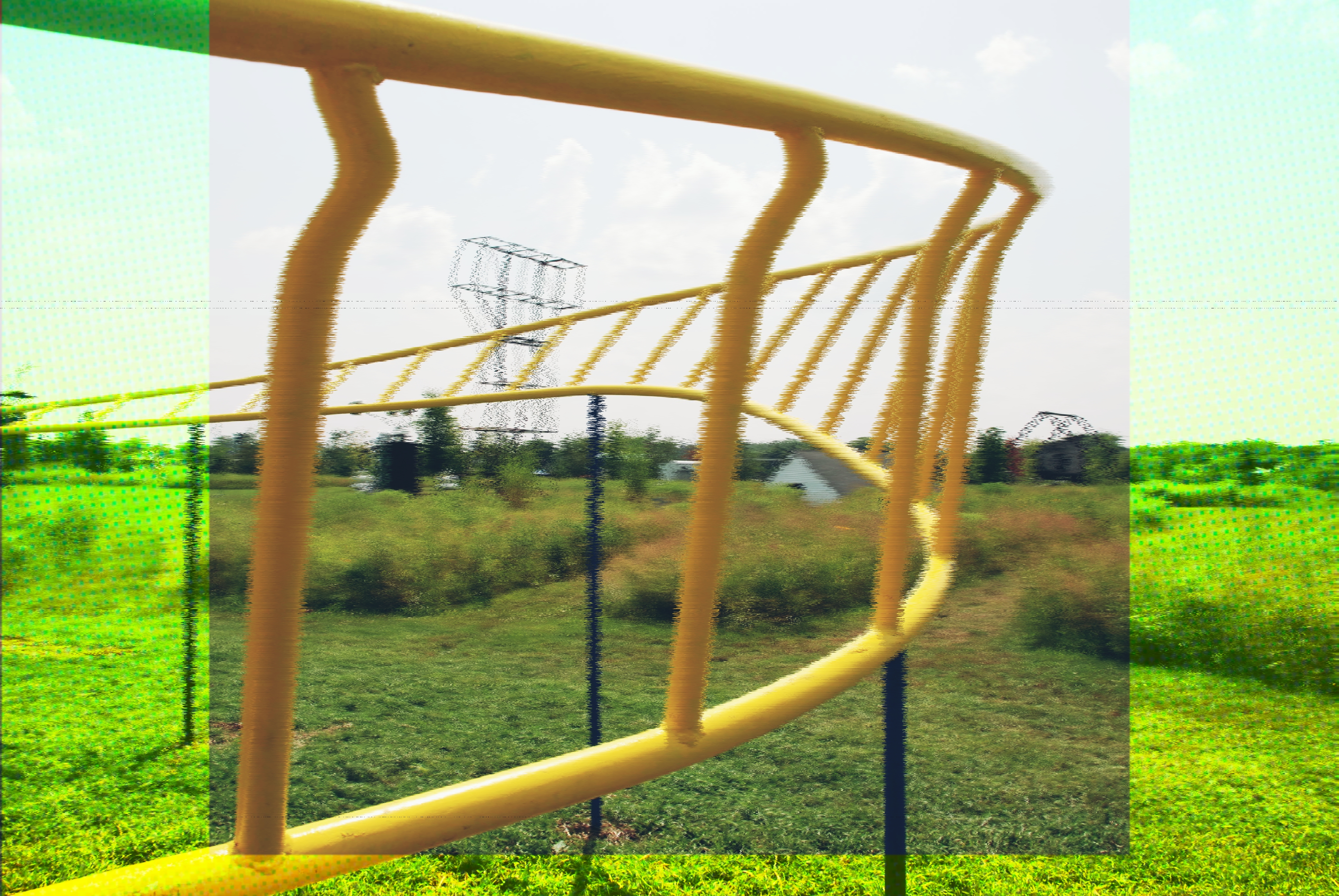 A steel sculpture with blue support poles and yellow twisting sets of bars, similar to something you’d encounter on a children’s playground. The original image has been modified to be blurrier and look a bit glitchy and a bright, almost neon green filter overlay has been applied, except for a square section in the center which retains the original colours.